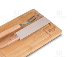 Kit churrasco composto por 3 peças (faca, garfo e espátula) e uma tábua de madeira.