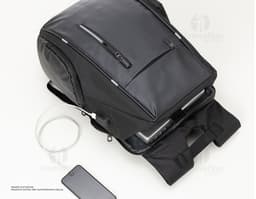 Synthetic leather laptop backpack, perfect for business or leisure travel. Modern and spacious, with a padded compartment to