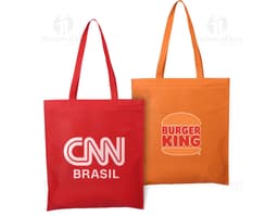 Sacola de compras de tecido não tecido (TNT) de 100g com alça de 60cm. A sacola é amarela e possui um design moderno e