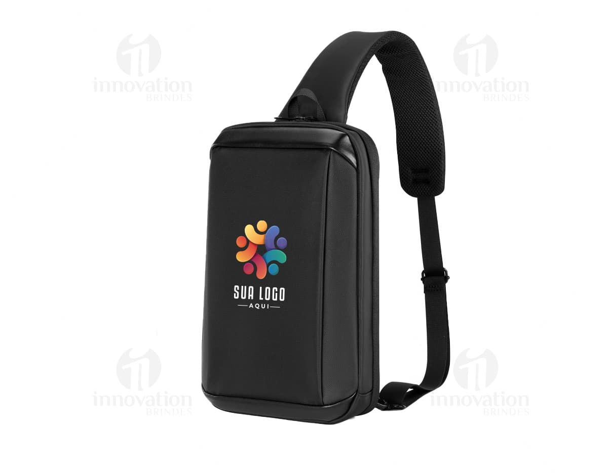 Headset preto com fio conectado a um dispositivo moderno, com etiqueta de preço. Aparece também um microfone próximo ao equipamento, indicando uso para escutar música ou comunicação.