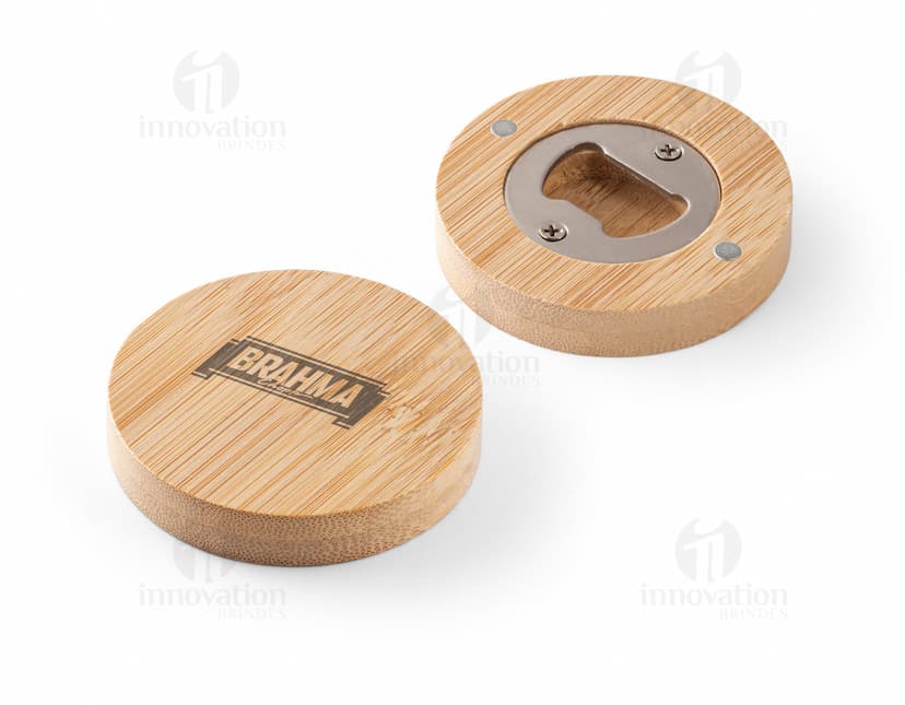 Porta copos com abridor, de madeira e metal, redondo e de cor marrom. Pode ser utilizado para apoiar copos ou garrafas, além de possuir um abridor de garrafas integrado. Ideal para usar em refeições, para manter a mesa limpa e organizada.