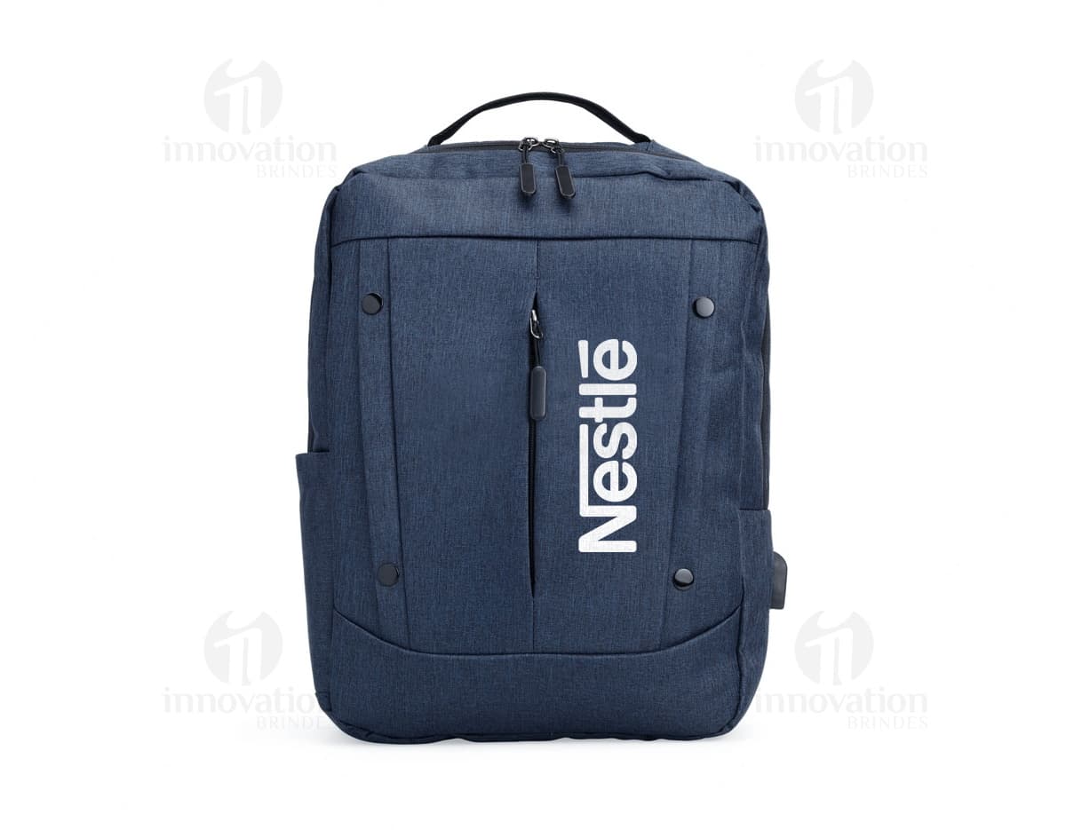 Mochila de nylon de 21 litros em marrom e preto, com alça de couro, zíperes, bolsos e tecido resistente. Ideal para viagens, uso casual e estilo moderno.