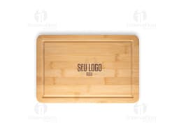 Bamboo cutting board on a blank brown wooden block, with paper and box around it.