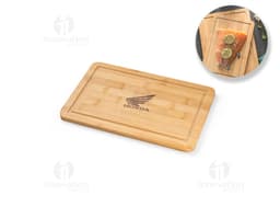 Bamboo cutting board on a blank brown wooden block, with paper and box around it.