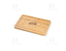 Bamboo cutting board on a blank brown wooden block, with paper and box around it.