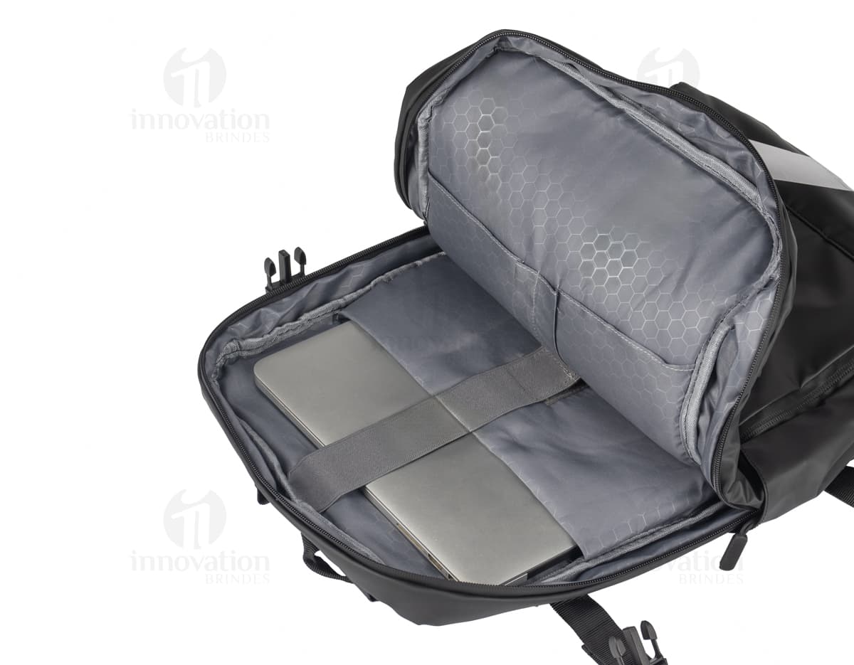 Mochila para Notebook de couro preto, elegante e moderna. A imagem mostra o produto em um cenário de escritório vazio, com um sofá e uma cadeira de couro. A mochila é um acessório de luxo e estilo para o homem de negócios bem-sucedido.