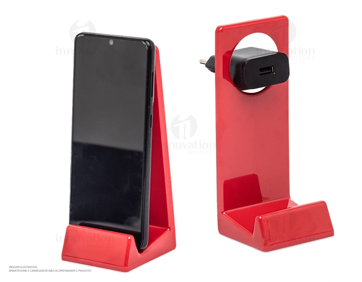 Suporte para celular em design 3D, feito de plástico preto. O produto possui um alto-falante, espaço para notebook e botão. Embalado em uma caixa moderna e vazio, pronto para ser utilizado em casa ou no escritório. Ideal para armazenar e exibir seu dispositivo eletrônico com segurança.