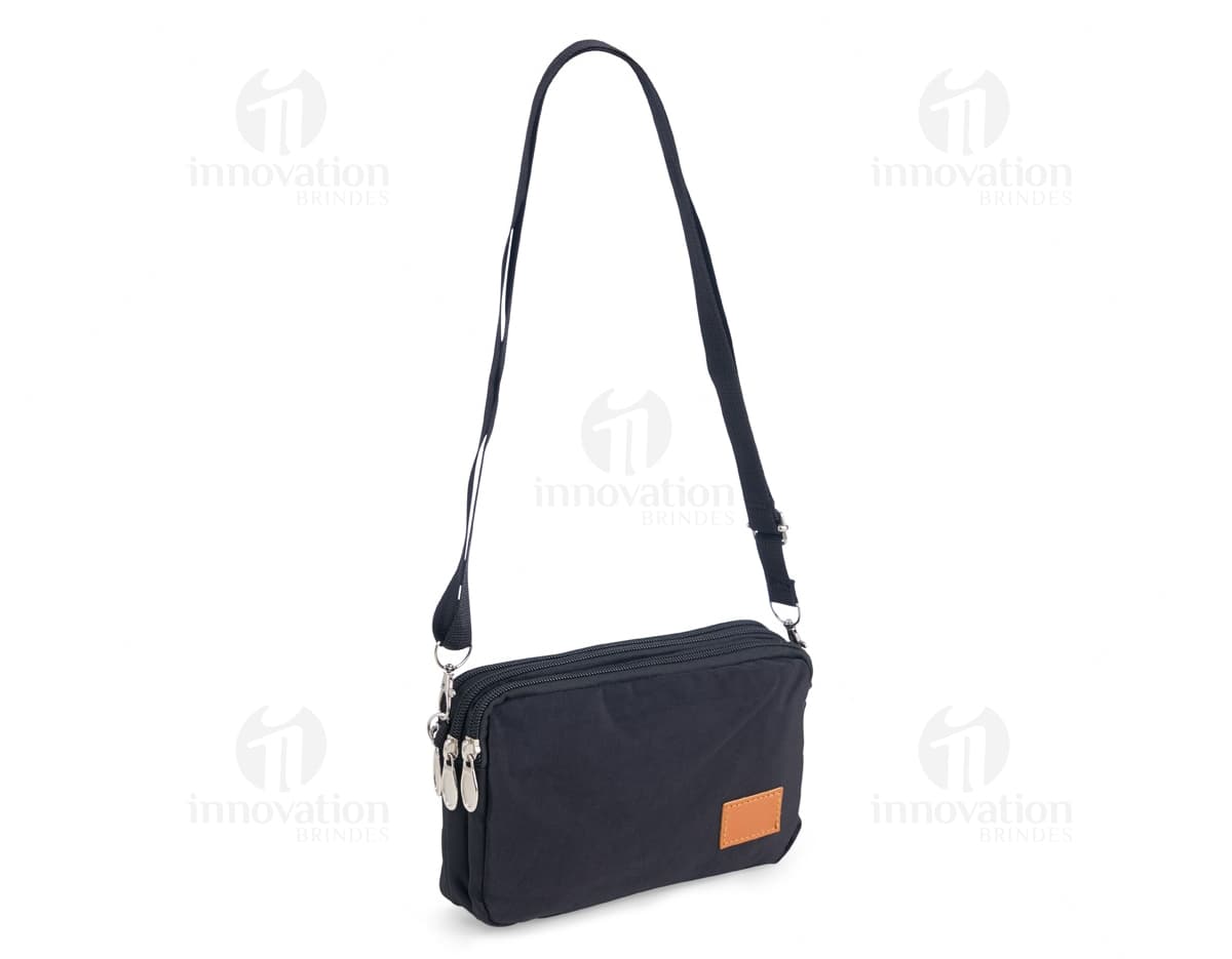 Mini Bolsa Transversal de Nylon preta, ideal para viagens e negócios. Possui alça ajustável, fecho em zíper e design moderno e elegante. Ótima opção para transporte de dinheiro e objetos pessoais com segurança.