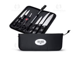 7-piece stainless steel BBQ set, including knife, fork, tongs, spatula, cleaning brush, sharpener, and black case. Ideal for