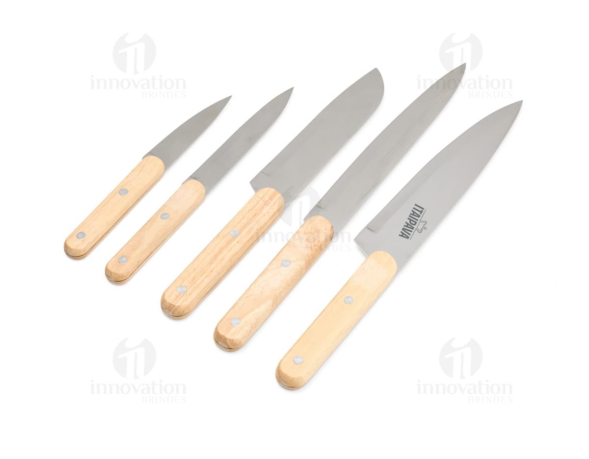 Kit Churrasco 5 Peças em aço inoxidável, contendo faca, garfo, espátula, pinça e escova de limpeza, dispostas em uma caixa de madeira. Ideal para preparar churrascos ao ar livre.