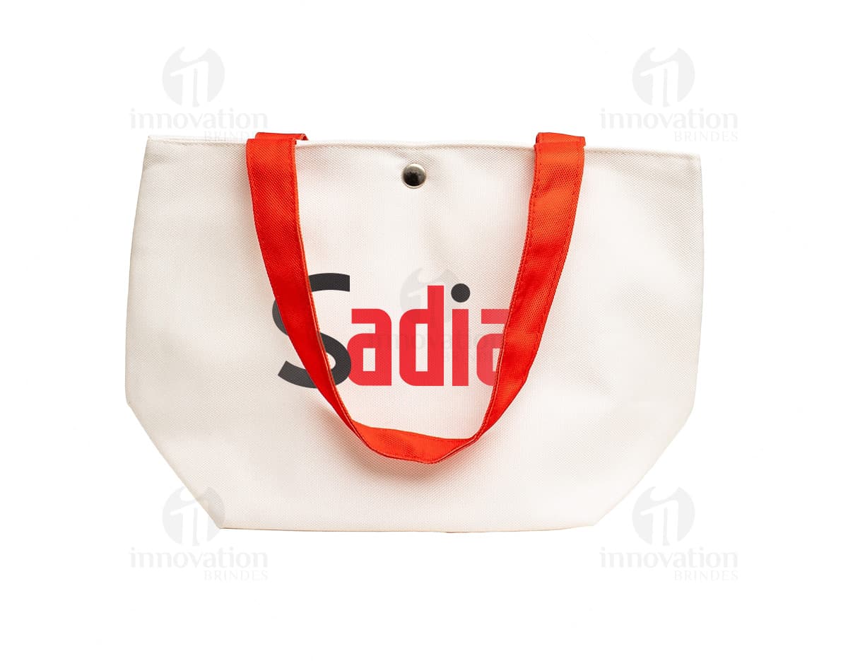 Bolsa de lona na cor azul-marinho com alças de couro marrom e fecho de zíper na parte superior.