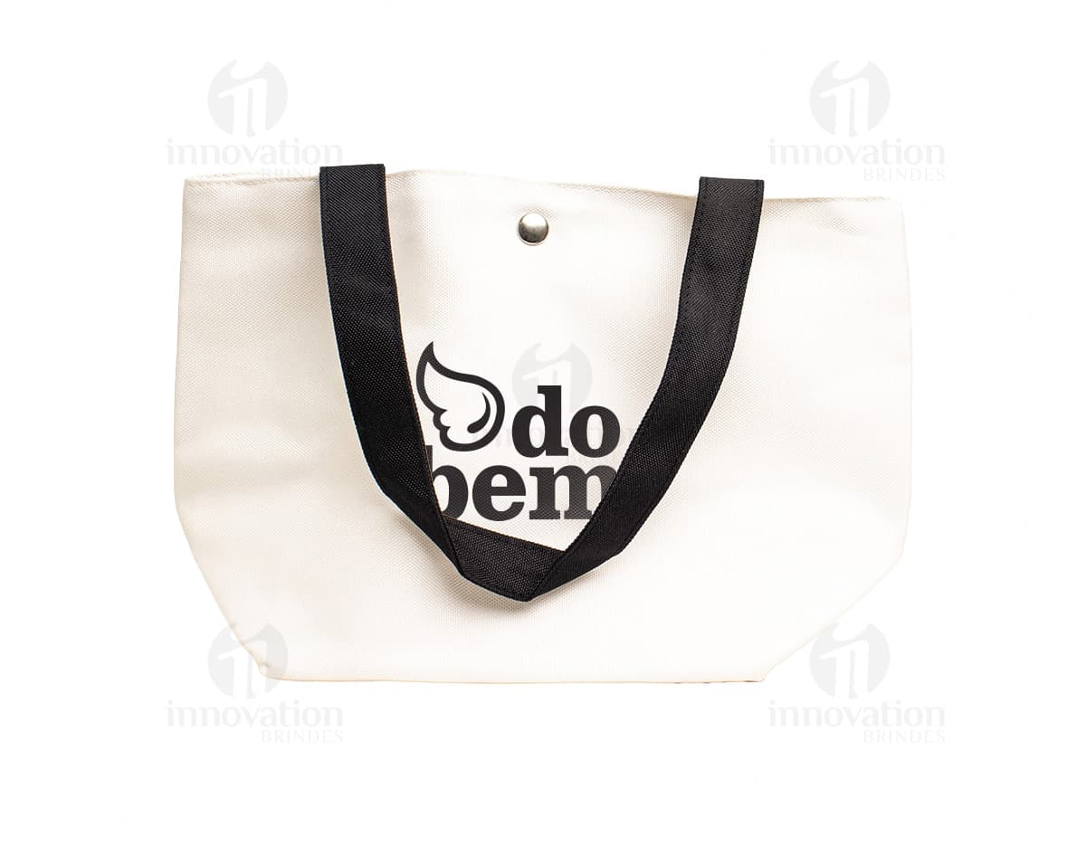 Bolsa de lona na cor azul-marinho com alças de couro marrom e fecho de zíper na parte superior.