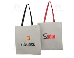 Borsa in cotone di colore blu con manici corti e dettagli in cucitura bianca.