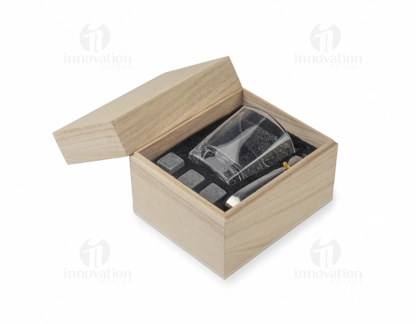 Kit Drink em uma caixa de papelão marrom. A embalagem está aberta e contém várias garrafas e copos empilhados. Ao redor da caixa, há diversos objetos de decoração e símbolos de riqueza, como um cofre, livros, um baú e uma impressora.