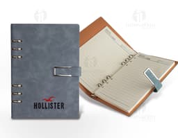 Caderno Fichário PU em cor preta, com fecho magnético e ferragem prateada.