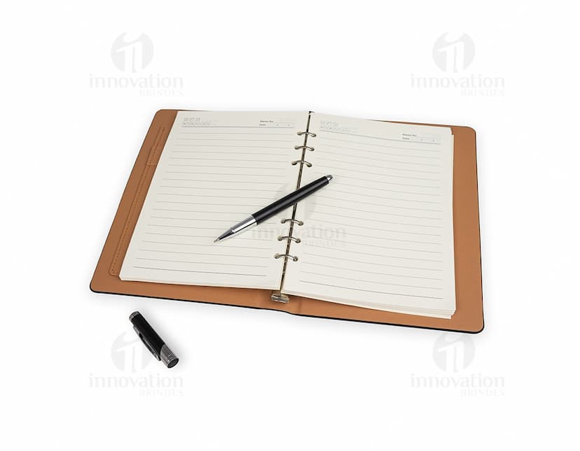 Kit executivo 2 peças composto por uma agenda preta de couro e uma caneta prateada.