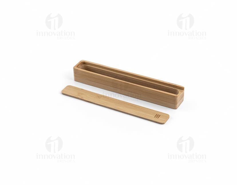 Estojo em bambu com fecho dourado, contendo lápis, caneta, régua e apontador.