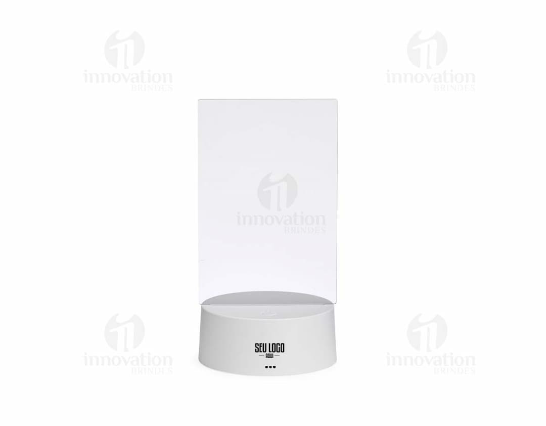 Luminária Led de Mesa na cor preta, com hastes flexíveis e base redonda. Acesa, iluminando um ambiente com luz branca.