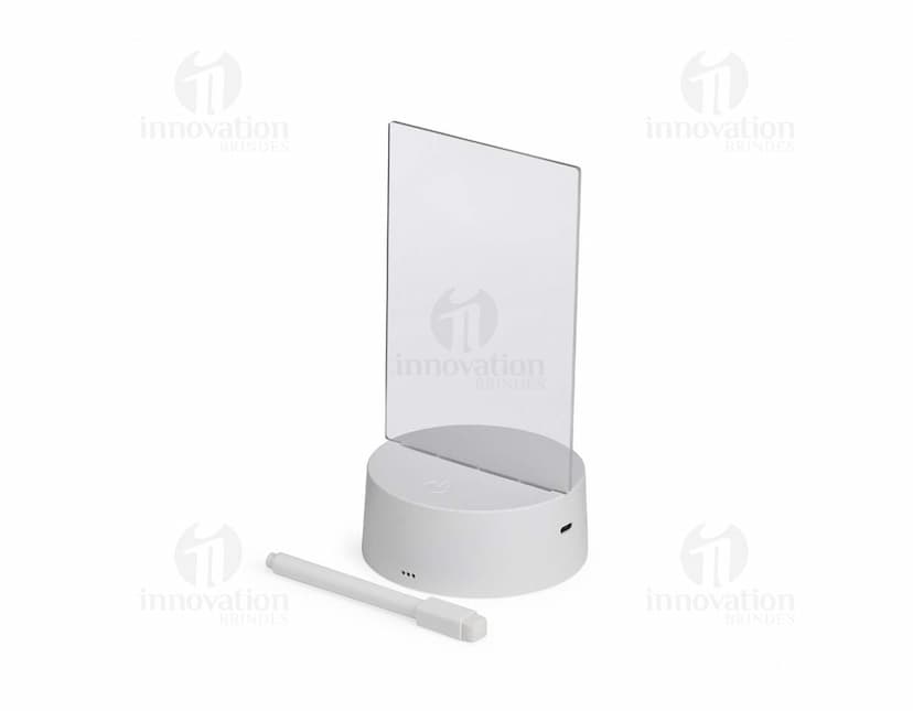 Luminária Led de Mesa na cor preta, com hastes flexíveis e base redonda. Acesa, iluminando um ambiente com luz branca.