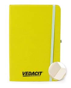 Caderneta de couro sintético vazia em um escritório amarelo, com espaço para inserir notas e documentos.