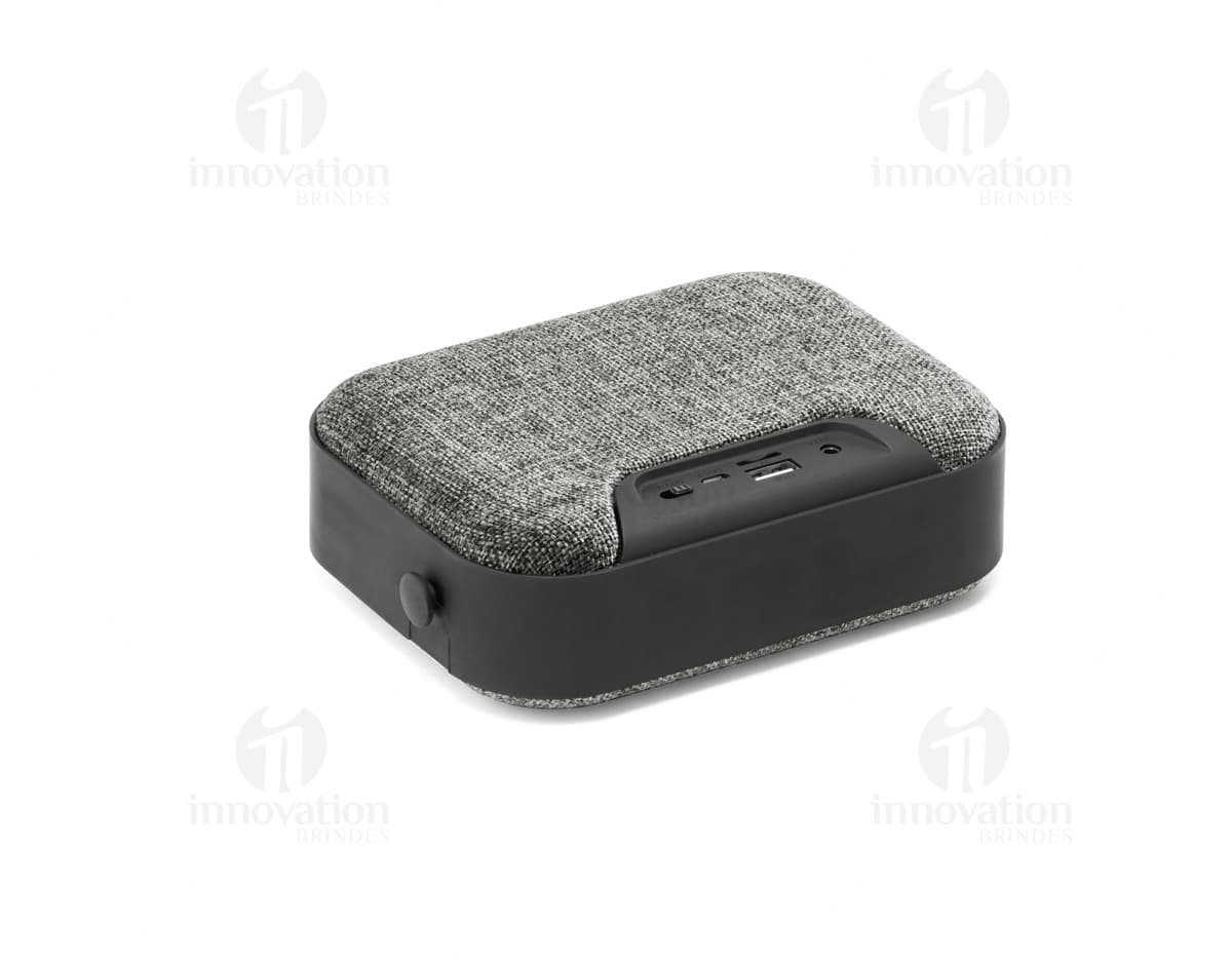 Caixa de som portátil TED em couro marrom e metal preto, elegante e moderna, com alça e zíper. Ideal para viagens e armazenamento de acessórios.