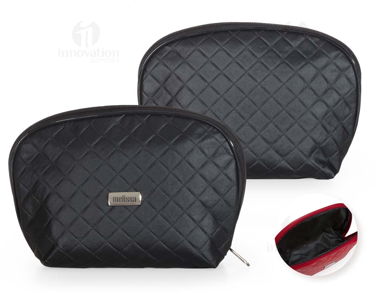 Necessaire de couro marrom com matelassê, estilo vintage, com fecho de fivela e alça de metal. O objeto está aberto, mostrando o interior vazio e forrado de papel. O design é elegante e fashion, com detalhes em couro e metal brilhante.