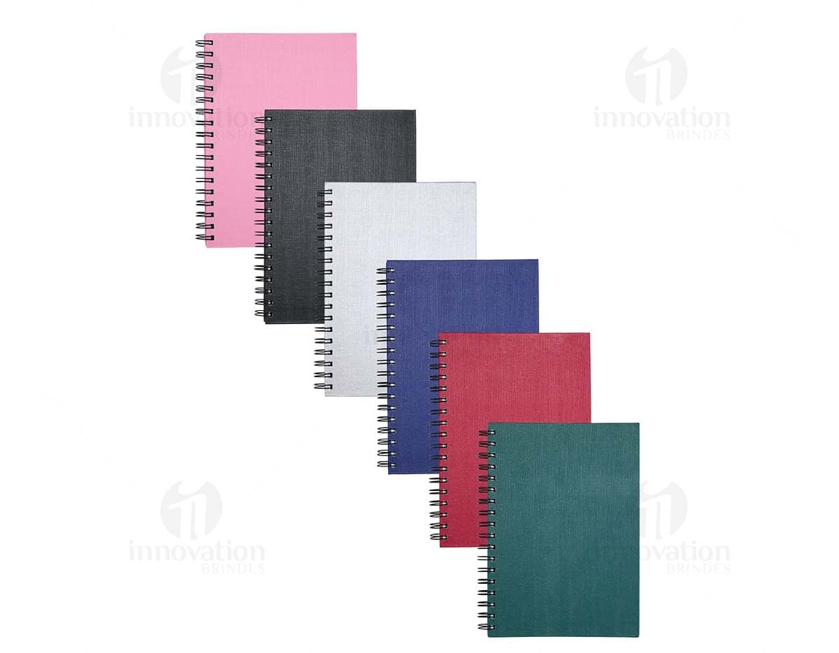 Caderno Linho com capa de tecido bege e elástico marrom.