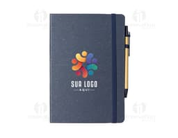 Rice fiber notebook with pen on a white background. The notebook is light brown with black details on the cover. The pen is