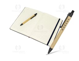 Rice fiber notebook with pen on a white background. The notebook is light brown with black details on the cover. The pen is