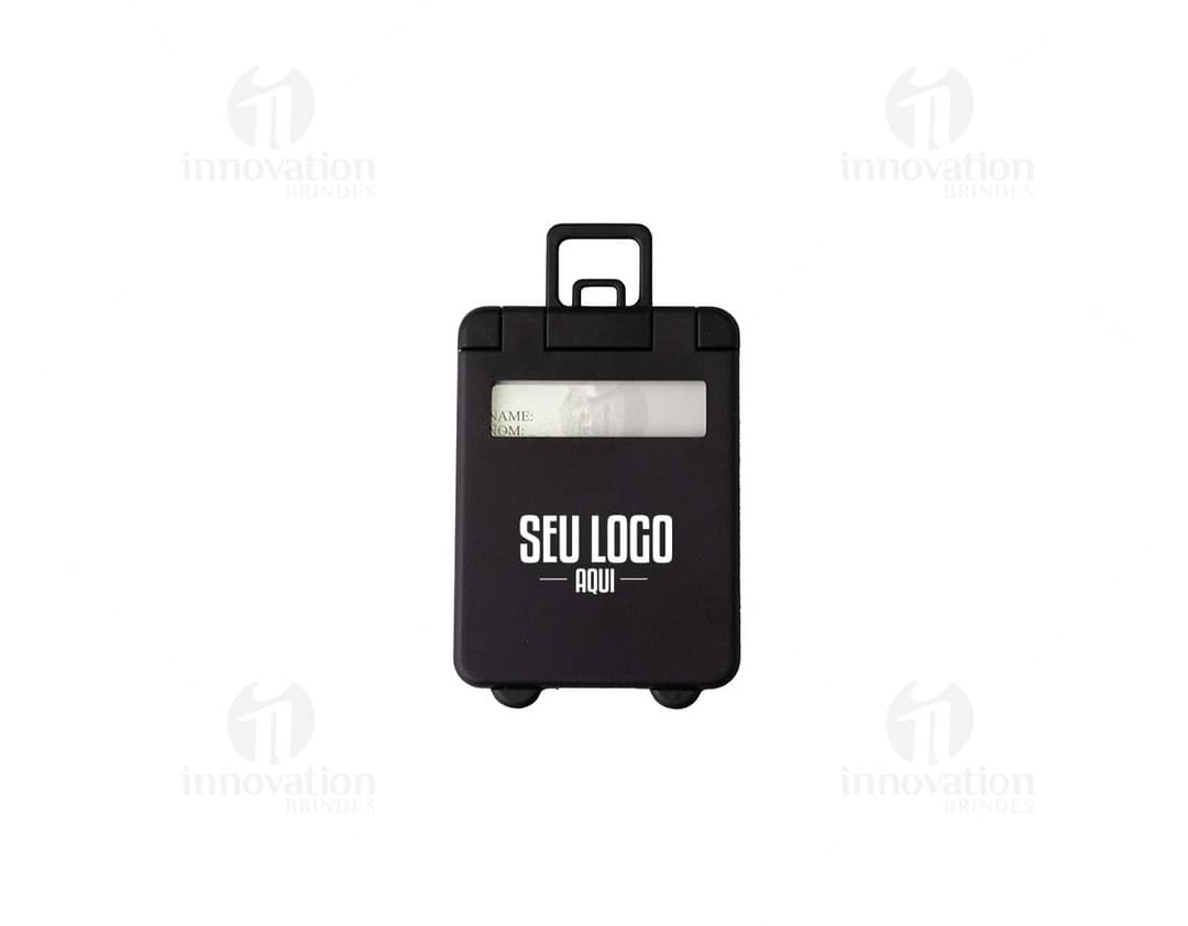 Brown leather luggage identifier tag with gold metal details and a strap for attaching to luggage.