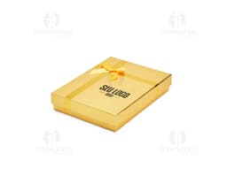 Red gift box with a golden bow and small shiny details.