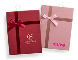 Red gift box with a golden bow and small shiny details.