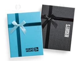 Red gift box with a golden bow and small shiny details.