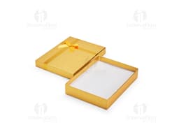 Red gift box with a golden bow and small shiny details.