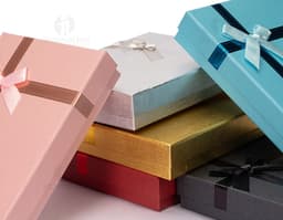 Red gift box with a golden bow and small shiny details.