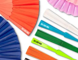 Colorful plastic fan with a modern and shiny design. The fan features geometric shapes in shades of yellow, orange, violet