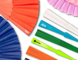 Colorful plastic fan with a modern and shiny design. The fan features geometric shapes in shades of yellow, orange, violet