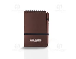 Bloco de anotações marrom com aroma de café de 70 folhas, sobre uma mesa de escritório. No bloco, é possível ver linhas para
