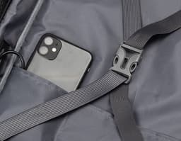 Homem de negócios sentado no carro, com cinto de segurança, dirigindo e utilizando uma mochila pasta para notebook. Ele está
