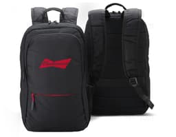 Smiling and successful businessman in a black suit, holding a 25L nylon backpack. The man is standing, looking confident and