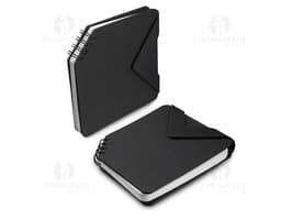 Black leather mini notebook open on an office desk, next to a laptop and various electronic devices. It contains blank pages