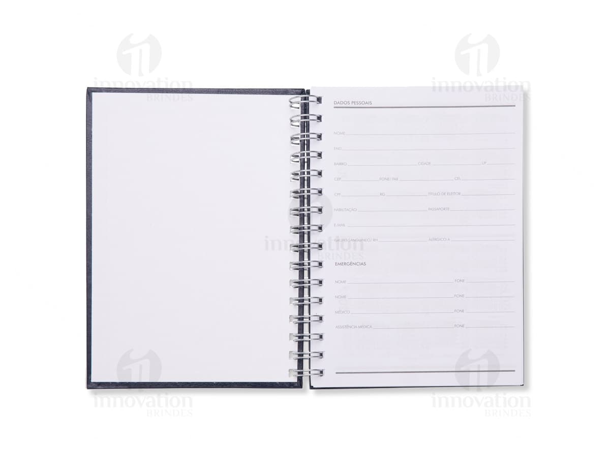Caderno pequeno com divisórias em tons de azul e rosa. O caderno está fechado e tem detalhes em dourado. Caderno pequeno com divisórias em tons de azul e rosa. O caderno está fechado e tem detalhes em dourado.