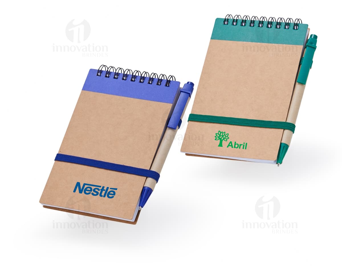 Bloco de anotações 14x9 em uma mesa de escritório, com páginas em branco e um papel adesivo amarelo. O objeto é utilizado para fazer lembretes, anotar informações ou mensagens. Há espaço para escrever e guardar documentos importantes. Bloco de anotações 14x9 em uma mesa de escritório, com páginas em branco e um papel adesivo amarelo. O objeto é utilizado para fazer lembretes, anotar informações ou mensagens. Há espaço para escrever e guardar documentos importantes.
